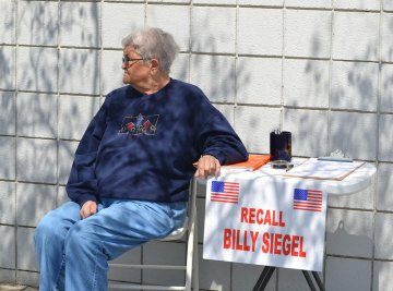 Jane Dart collects signatures Saturday by the post office.